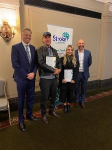 Three men and one woman standing together at the Stroke Foundation Awards. In the middle, Stroke award finalists Richard Crooks and Mikaela Reilly. Two gentleman either side are Warren Brooks and Shane Patella, representatives from the awards sponsor Ipsen