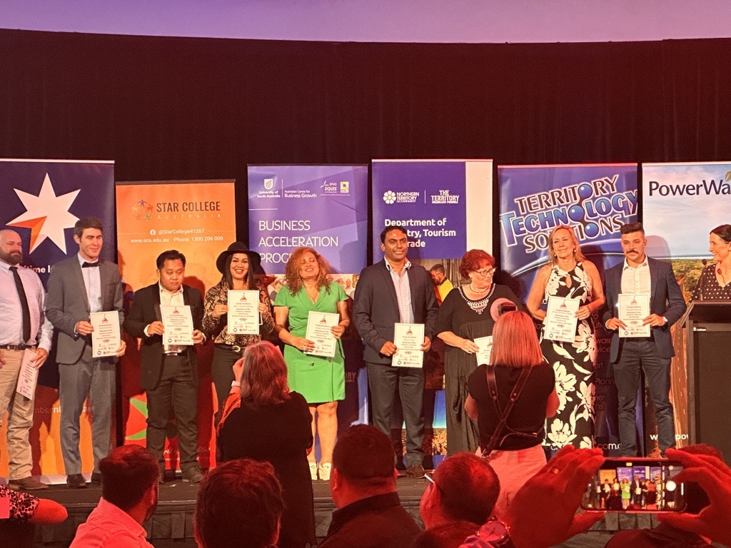 Director Dharun Madathil standing on stage with other nominees in the Business Excellence award category from Northern Territory Chamber of Commerce.